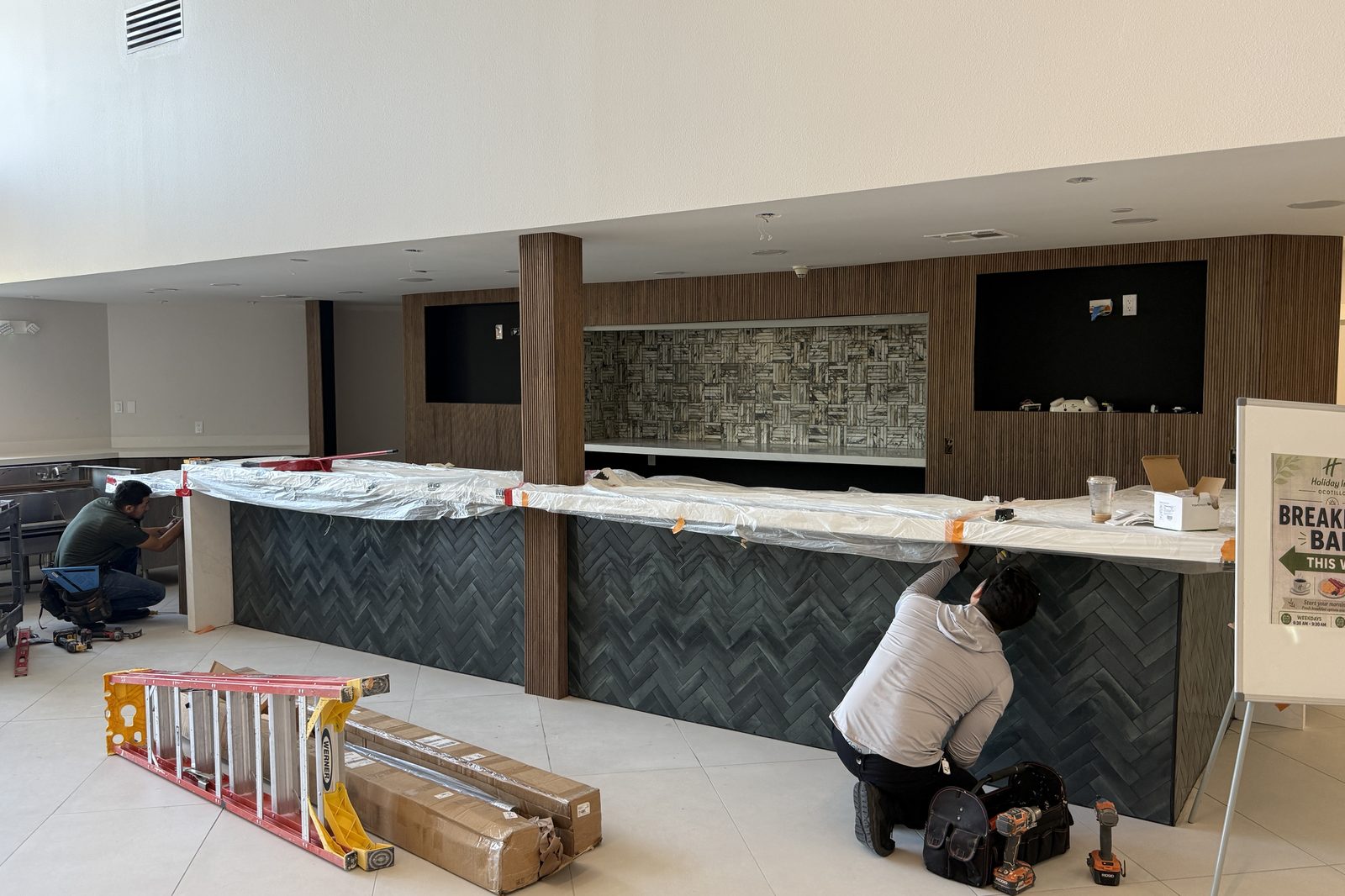 Custom bar millwork being installed by the construction crew