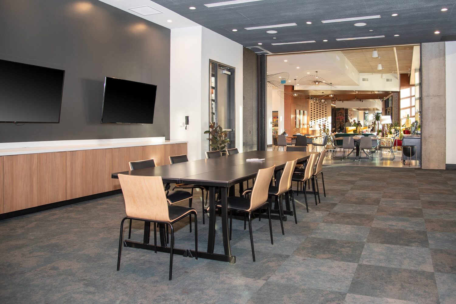 Boardroom table and screens in a working meeting room